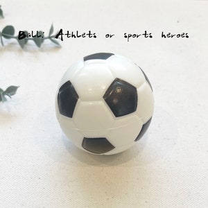 May include: A white and black soccer ball with a textured surface.