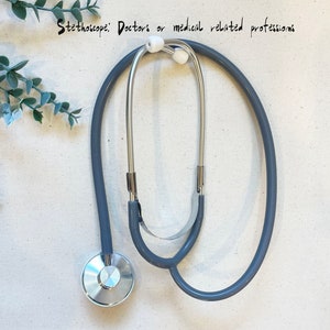 May include: A gray stethoscope with silver earpieces and a silver chest piece.  "Stethoscope: Doctors or medical related professions"