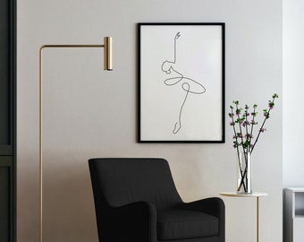 May include: A black armchair with a gold floor lamp and a framed line drawing of a dancer in a white room. A vase with pink flowers sits on a small gold side table.