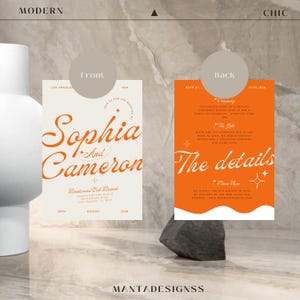 May include: A wedding invitation with a modern design. The front features the names "Sophia and Cameron" in orange script on a cream background. The back features the details of the wedding, including the date, time, and location, in orange text on a white background.