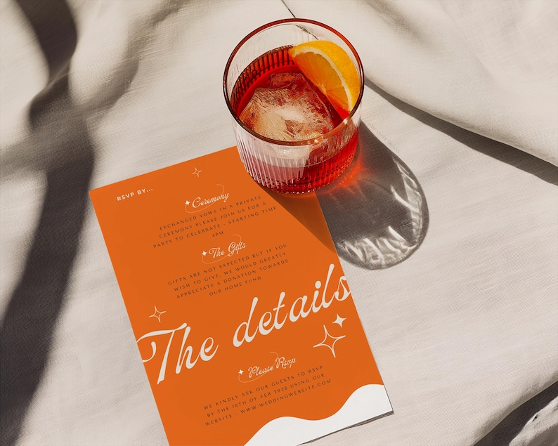 May include: Orange and white wedding invitation with the text "The details" in a white script font. The invitation has a white wave design at the bottom and stars in the top corners. The background is orange with a white border.