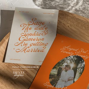 May include: A cream-colored save the date card with orange cursive text reading Save The Date Sophia & Cameron Are Getting Married, and an orange card featuring a photo of a couple in an oval frame with the text August 3rd, Twenty Twenty Six.