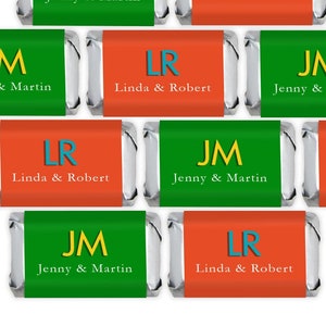 May include: Eight personalized mini chocolate bar wrappers with green and orange backgrounds. The wrappers feature the initials "JM" and "LR" with the names "Jenny & Martin" and "Linda & Robert" printed below.