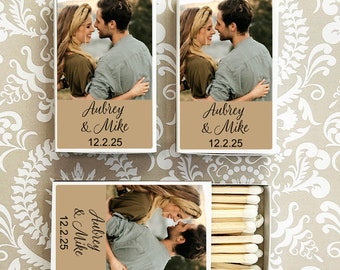 May include: White matchbox with a brown background and a photo of a couple. The text on the box reads "Aubrey & Mike 12.2.25".
