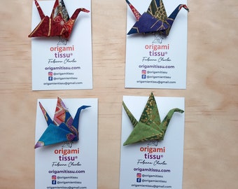 Fabric origami brooches in the shape of cranes