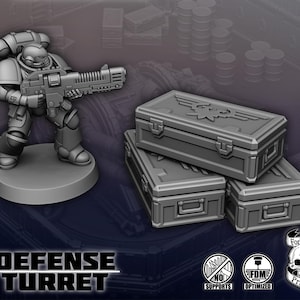 May include: A gray plastic miniature of a space marine holding a gun, standing on a round base. Three gray plastic boxes with a raised eagle design are stacked on top of each other. The boxes are labeled "Defense Turret".