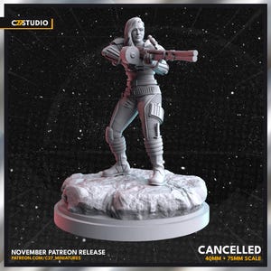 May include: A gray 3D printed miniature of a female figure holding a weapon. The figure is standing on a rocky base. The miniature is 40mm + 75mm scale. The text "CANCELLED" is visible in the image.