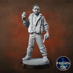 May include: A gray 3D-printed figurine of a man in a bomber jacket, holding a can and a gun. The figure is standing on a circular base with a cobblestone pattern. The jacket has a fur-like collar. The figure is wearing gloves and boots.