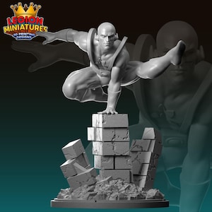 May include: A gray 3D printed miniature of a superhero in a dynamic pose, standing on a pile of broken bricks. The superhero is wearing a costume with a belt and a symbol on the chest. The miniature is designed for tabletop gaming or display.