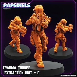 May include: Three orange plastic miniature figures of soldiers wearing futuristic armor and helmets, holding weapons. The figures are standing on black circular bases. The text "Trauma Troupe Extraction Unit - C" is printed below the figures.