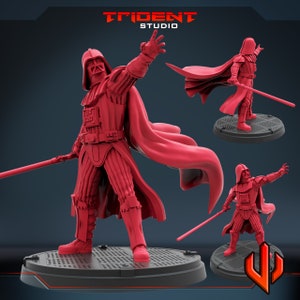 May include: A red plastic miniature figurine of Darth Vader from Star Wars, holding a lightsaber. The figurine is posed in a dramatic stance with a cape flowing behind him. The figurine is on a black base with a grid pattern.