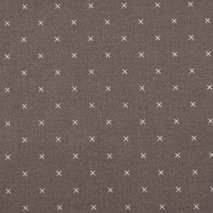 May include: A brown fabric with a white pattern of small crosses.
