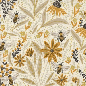 May include: A white fabric with a gold and yellow floral pattern. The pattern features bees, flowers, and leaves. The fabric has a subtle shimmer.