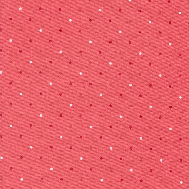 May include: A pink fabric with white and red polka dots.