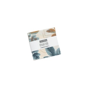 May include: A small fabric square with a white background and a blue and brown leaf pattern. The fabric is labeled "moda fabrics" and "decorum" with the color "basicgrey".