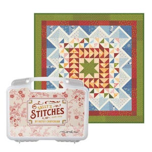 May include: A colorful quilt with a star pattern and a clear plastic case with the text "SALLY'S STITCHES" and floral design. The quilt features red, blue, green, and yellow geometric shapes. The case is decorated with pink flowers.