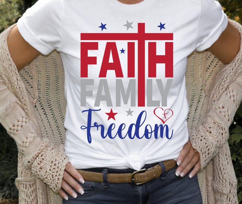 May include: White t-shirt with a red, white, and blue graphic that says "FAITH FAMILY FREEDOM" with a cross and stars.