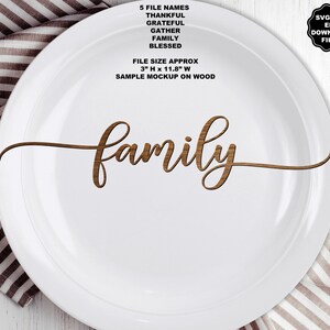 May include: A white plate featuring the word family in a brown wood grain script font. Text above reads 5 FILE NAMES THANKFUL GRATEFUL GATHER FAMILY BLESSED and FILE SIZE APPROX 3" H x 11.8" W SAMPLE MOCKUP ON WOOD. A black badge reads SVG PNG EPS DOWNLOAD FILES.