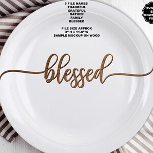 May include: A white plate featuring the brown wood-grain text 'blessed' in a cursive font. Text above reads: 5 FILE NAMES THANKFUL GRATEFUL GATHER FAMILY BLESSED. FILE SIZE APPROX 3" H x 11.8" W. SAMPLE MOCKUP ON WOOD. A black badge reads: SVG PNG EPS DOWNLOAD FILES.