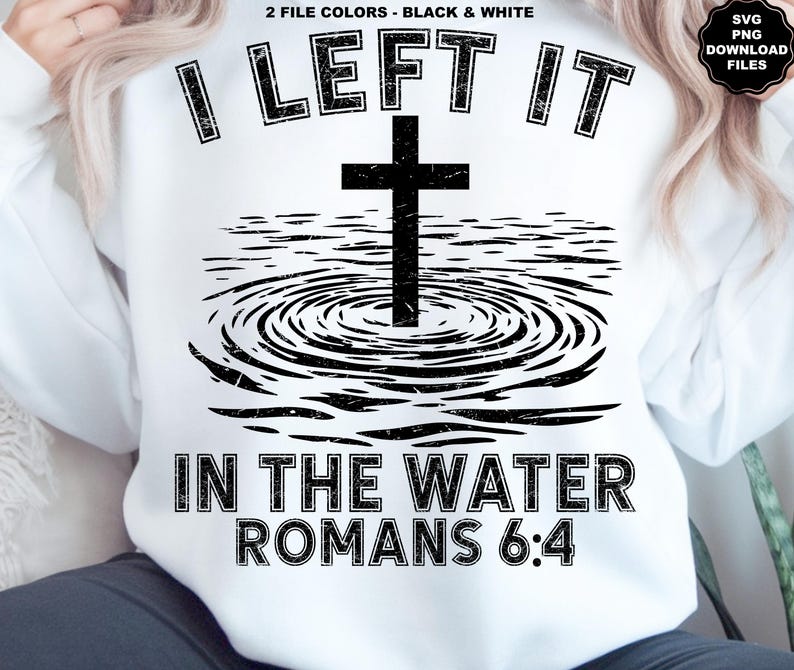 May include: White sweatshirt with a black graphic design. The design features a cross in water with the text "I LEFT IT IN THE WATER ROMANS 6:4". The design is in a distressed style.