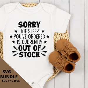 May include: White baby onesie with black text that reads "Sorry the sleep you've ordered is currently out of stock". The onesie is on a woven basket with brown baby shoes.