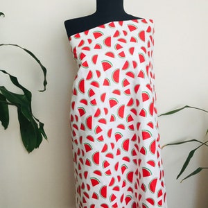 May include: White fabric with a repeating pattern of red watermelon slices.