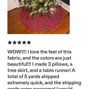 May include: A circular Christmas tree skirt featuring a red, black, and white plaid tartan pattern. The fabric skirt is positioned at the base of a decorated evergreen tree adorned with gold ornaments, white snowflake decorations, and warm string lights.