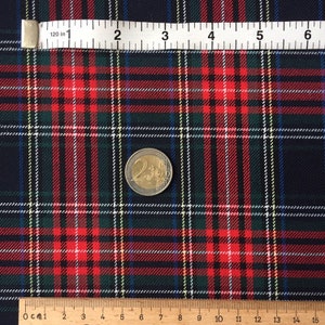 May include: Red, green and white plaid fabric with a ruler and a Euro coin for scale. The fabric has a fine weave and a soft texture.