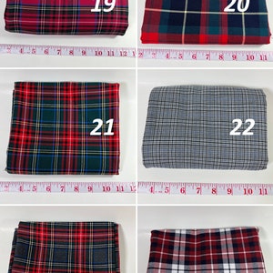 May include: Six folded fabric swatches labeled 19 through 24, each featuring distinct plaid patterns in red, green, blue, black, white, and gray. A white measuring tape is visible below each swatch, showing measurements up to 11 inches.