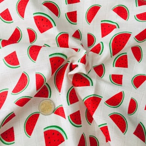 May include: White fabric with a repeating pattern of red watermelon slices. The fabric is textured and has a subtle grid pattern.