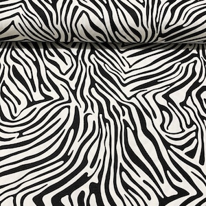 May include: Close-up of a fabric with a striking zebra stripe design. The material displays black stripes against a white backdrop, creating a high-contrast pattern. The fabric is folded, revealing its texture and how it drapes. Suitable for home decor or fashion.
