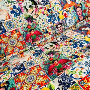 May include: A colorful fabric with a repeating pattern of colorful tiles featuring a portrait of Frida Kahlo. The tiles are arranged in a patchwork design.