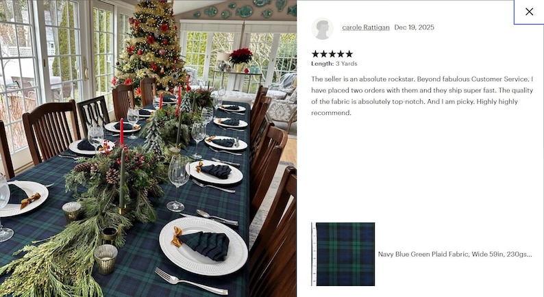 May include: A navy blue and green plaid fabric tablecloth covering a long dining table. The table is set with white plates, folded dark napkins, clear glassware, silver cutlery, and festive evergreen centerpieces with pinecones and red candles.