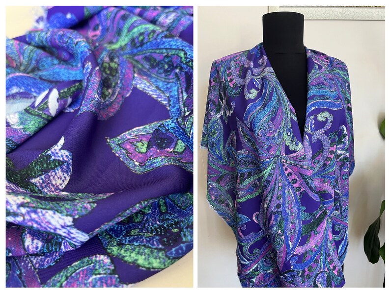 May include: Purple fabric with a paisley pattern in shades of blue, green, and pink. The fabric is shown draped over a mannequin.