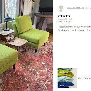 May include: Two lime green armchairs with a textured fabric, in a living room setting. The chairs have dark wooden legs and are on a patterned red rug. A small wooden side table and a lamp are between the chairs.