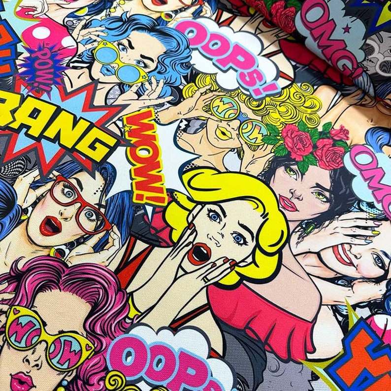May include: A colorful fabric with a pop art design featuring women with exaggerated features, bold text, and bright colors. The text includes "OMG", "Oops", "Wow", "Bang", and "Pow!"