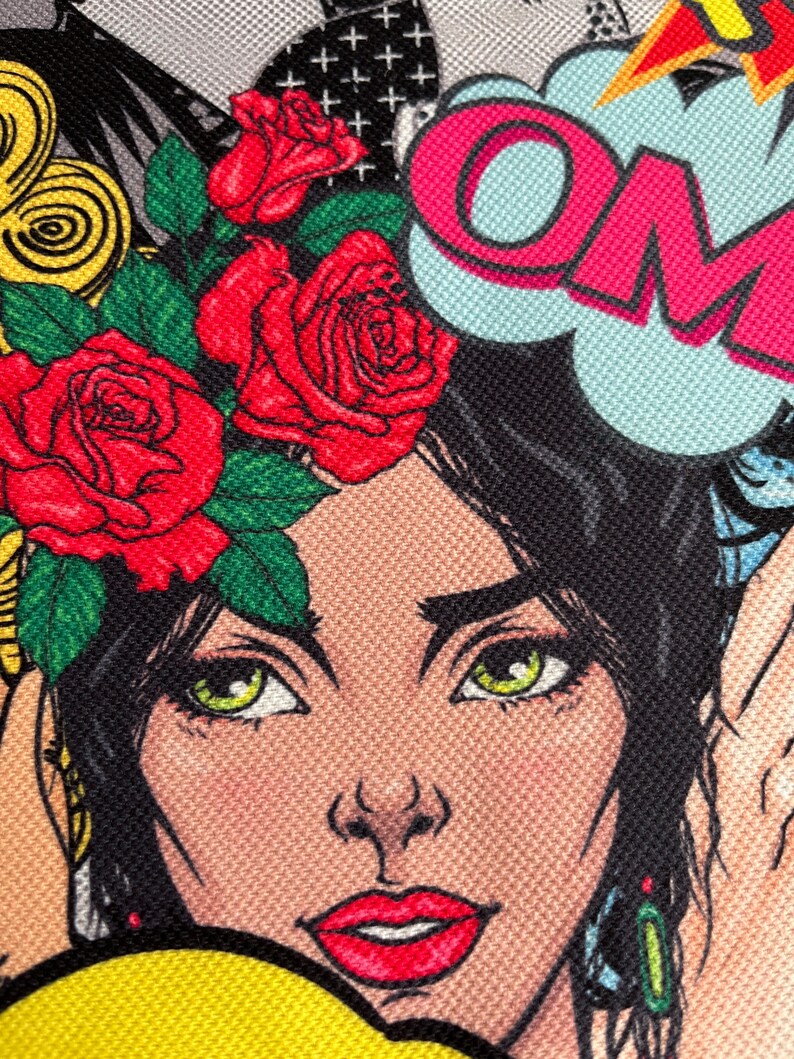 May include: A colorful illustration of a woman with red roses in her hair. The woman has green eyes and red lips. The background is a comic book style with the word "OM" in a speech bubble.