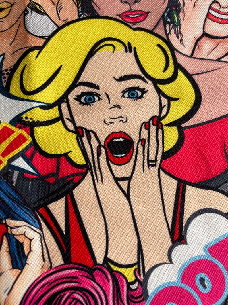May include: A close-up of a woman's face with bright blue eyes and red lipstick. She is wearing a red dress and has her hands on her cheeks in a surprised expression. The background is a colorful comic book style pattern.