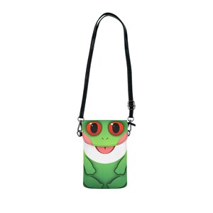 May include: A green and white crossbody bag featuring a cartoon frog design. The bag has a black strap and a flap closure. The frog has red eyes and a pink tongue. The bag is designed to hold a phone.