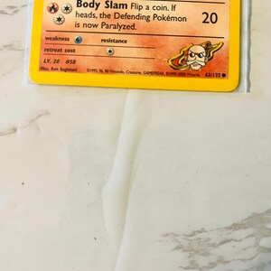 以下が含まれることがあります： オレンジと黄色の犬のような生き物が描かれたポケモンカード。カードには、20のダメージ値を含む、生き物の能力とステータスを説明するテキストがあります。カードには#58と62/132と記載されています。