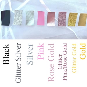 May include: A color chart featuring eight rectangular swatches in black, glitter silver, silver, pink, rose gold, glitter pink/rose gold, glitter gold, and gold. Each swatch is labeled with its corresponding color name in black text below it.