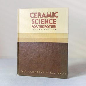 May include: A hardcover book titled "CERAMIC SCIENCE FOR THE POTTER" in red text on a cream-colored background. The lower portion of the book is brown. The book is a second edition, with the authors' names at the bottom.