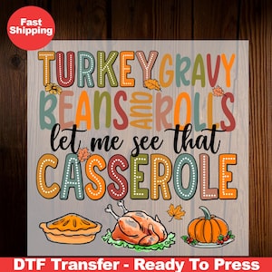 May include: A colorful Thanksgiving-themed design with the text "Turkey Gravy Beans and Rolls Let Me See That Casserole". The design features a turkey, a pumpkin, and a pie.