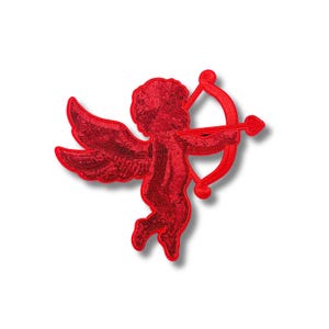 May include: Red sequin applique of a cupid holding a bow and arrow.