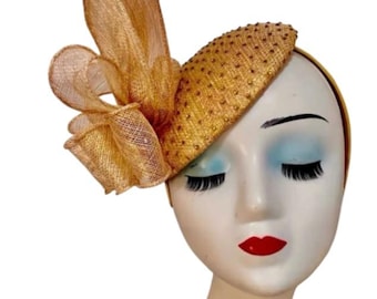 Elegant teardrop fascinator with a stone base cap and paired with a sculptured bow