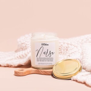 a jar of cream next to a wooden spoon