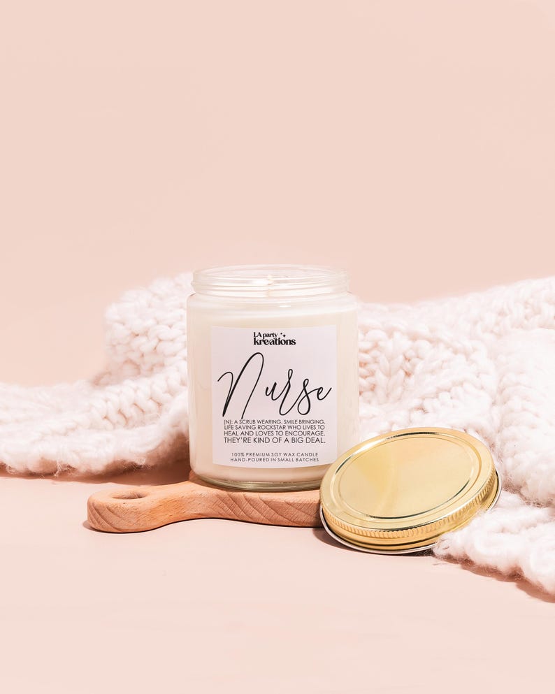 a jar of cream next to a wooden spoon
