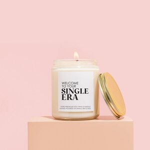 a candle sitting on top of a pink block