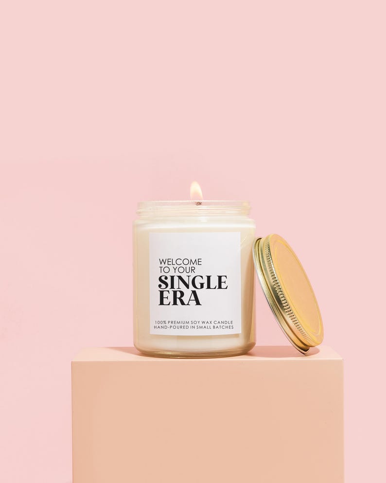 a candle sitting on top of a pink block