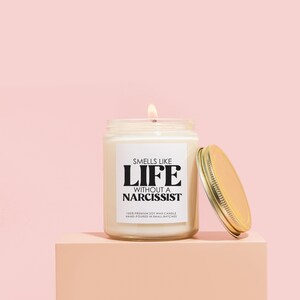 a candle sitting on top of a pink block